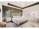 Spacious main bedroom with a tray ceiling, plush carpeting, and stylish decor at 2140 Ravencliff Dr, Austell, GA 30168