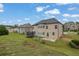 Spacious backyard with ample lawn space, patio area, and recreational equipment, perfect for outdoor activities at 2740 Longacre Park Way, Lawrenceville, GA 30044