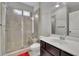 Bathroom with a large walk-in shower, decorative window and a spacious vanity area at 2740 Longacre Park Way, Lawrenceville, GA 30044