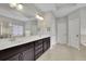 Bathroom featuring a double vanity, lots of counter space, tile floors, and decorative window at 2740 Longacre Park Way, Lawrenceville, GA 30044