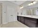 Spacious bathroom featuring tile floors, double vanity sinks and decorative lighting at 2740 Longacre Park Way, Lawrenceville, GA 30044