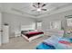 Spacious bedroom with a white trim tray ceiling, ceiling fan and a large window at 2740 Longacre Park Way, Lawrenceville, GA 30044