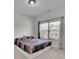 Neutral bedroom features a bed and a window offering an exterior view at 2740 Longacre Park Way, Lawrenceville, GA 30044
