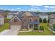 Beautiful brick home featuring a well-maintained lawn and garden, creating an inviting curb appeal at 2740 Longacre Park Way, Lawrenceville, GA 30044