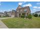 Attractive brick home with a well-kept lawn and landscaped garden at 2740 Longacre Park Way, Lawrenceville, GA 30044