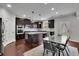 Modern kitchen featuring dark wood cabinets, granite countertops and an island at 2740 Longacre Park Way, Lawrenceville, GA 30044