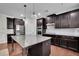 Well-appointed kitchen with dark wood cabinets, granite countertops, and island at 2740 Longacre Park Way, Lawrenceville, GA 30044