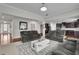 Open concept living room with hardwood floors, grey sofas and modern finishes at 2740 Longacre Park Way, Lawrenceville, GA 30044