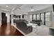 Comfortable living room featuring hardwood floors, grey sofas and a modern rug at 2740 Longacre Park Way, Lawrenceville, GA 30044