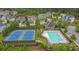 Aerial view of community pool and tennis courts surrounded by lush landscaping, offering recreational amenities at 2740 Longacre Park Way, Lawrenceville, GA 30044