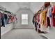 Spacious walk-in closet with neutral walls and lots of room for hanging clothes and storage at 2740 Longacre Park Way, Lawrenceville, GA 30044