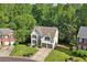 Aerial view of a two-story house with a two-car garage surrounded by lush greenery at 1097 Soaring Way, Marietta, GA 30062