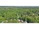 Stunning aerial view of a home nestled within a lush green landscape and tree coverage at 1097 Soaring Way, Marietta, GA 30062