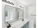 Bright bathroom featuring a double vanity with black fixtures, a large mirror, and modern lighting at 1097 Soaring Way, Marietta, GA 30062