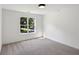 Bright, carpeted bedroom features a large window, filling the space with natural light at 1097 Soaring Way, Marietta, GA 30062