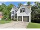 Charming two-story stucco home boasting an attached two-car garage and front yard with mature trees at 1097 Soaring Way, Marietta, GA 30062