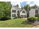 Attractive two-story home with a well-manicured lawn and mature trees in a suburban setting at 1097 Soaring Way, Marietta, GA 30062