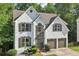 Charming two-story stucco home featuring a manicured lawn, shrubbery, and a two-car garage at 1097 Soaring Way, Marietta, GA 30062