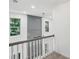 Second floor landing with view to the outside from a window, railing, and architectural details at 1097 Soaring Way, Marietta, GA 30062