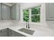 Beautiful kitchen features bright white countertops, gray cabinets, and a window offering natural light and a view at 1097 Soaring Way, Marietta, GA 30062