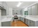 Well-lit kitchen boasts gray cabinets, stainless steel appliances, and white countertops at 1097 Soaring Way, Marietta, GA 30062