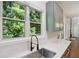 This updated kitchen features new appliances, white countertops, and large window with backyard views at 1097 Soaring Way, Marietta, GA 30062