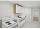 Kitchenette with white cabinetry and electric stove at 1097 Soaring Way, Marietta, GA 30062