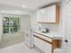 Kitchenette with white cabinetry and electric stove at 1097 Soaring Way, Marietta, GA 30062