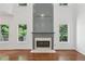 Bright living room with multiple windows, hardwood floors, and a cozy fireplace at 1097 Soaring Way, Marietta, GA 30062