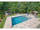 Stunning aerial view of the backyard pool, bar, gazebo and travertine decking at 3330 Riverwalk Way, Cumming, GA 30040