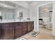 Spacious primary bath featuring dual sink vanity, granite countertops, and access to the bedroom at 3330 Riverwalk Way, Cumming, GA 30040