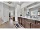 Elegant bathroom with dual vanity, granite countertops and large mirror at 3330 Riverwalk Way, Cumming, GA 30040