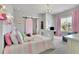 Lovely bedroom with pink accents features sliding barn door and cozy, inviting decor at 3330 Riverwalk Way, Cumming, GA 30040
