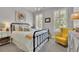 Cozy bedroom featuring a metal bed frame, bright yellow accents, and natural light at 3330 Riverwalk Way, Cumming, GA 30040