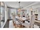 Elegant dining room featuring wood floors, modern lighting, and seating for six at 3330 Riverwalk Way, Cumming, GA 30040