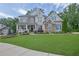 Charming two-story home featuring a beautifully landscaped yard and inviting front porch at 3330 Riverwalk Way, Cumming, GA 30040