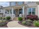 Charming front porch with stone accents, manicured landscaping, and a welcoming entrance at 3330 Riverwalk Way, Cumming, GA 30040