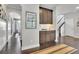 Inviting hallway features dark wood floors, arched doorway, and a built-in bar area with stylish cabinetry at 3330 Riverwalk Way, Cumming, GA 30040