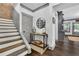 Hallway with stairs, a console table with decor, and access to the living area at 3330 Riverwalk Way, Cumming, GA 30040