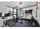 Well-equipped home gym with weight rack, exercise bike, and rowing machine at 3330 Riverwalk Way, Cumming, GA 30040