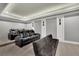Home theater with gray reclining chairs and gray sofa providing seating for the perfect movie night at 3330 Riverwalk Way, Cumming, GA 30040
