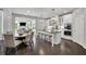 Bright, open kitchen featuring a large island, modern appliances, and seamless flow to the dining and living areas at 3330 Riverwalk Way, Cumming, GA 30040