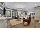 Spacious living area with hardwood floors, a modern chandelier, and access to the outdoor pool area at 3330 Riverwalk Way, Cumming, GA 30040