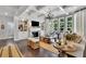 Spacious living room with coffered ceilings, fireplace and built-in bookshelves bathed in natural light at 3330 Riverwalk Way, Cumming, GA 30040