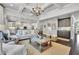Open-concept living space with coffered ceiling, seamless flow to the kitchen, and stylish built-in features at 3330 Riverwalk Way, Cumming, GA 30040