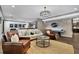 Open concept living room featuring air hockey and kitchenette, ideal for game night at 3330 Riverwalk Way, Cumming, GA 30040