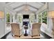 Cozy sunroom boasts natural light, vaulted ceilings, fireplace, and tranquil outdoor views at 3330 Riverwalk Way, Cumming, GA 30040