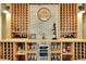 Close up of wine cellar showing brick wall feature and wine storage with cooler and glasses at 3330 Riverwalk Way, Cumming, GA 30040