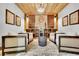Beautiful wine cellar with custom shelving, brick floor, and seating area for enjoying your favorite vintage at 3330 Riverwalk Way, Cumming, GA 30040