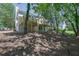 A backyard featuring a large deck, the home's exterior, and mature trees at 4999 Willow Creek Dr, Woodstock, GA 30188